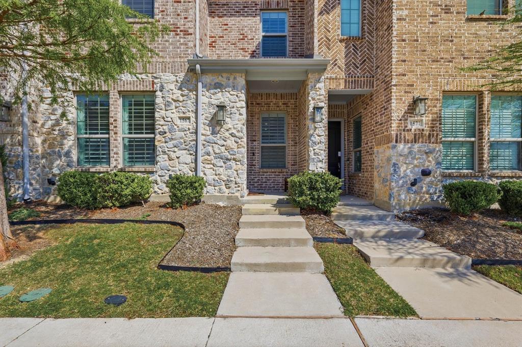 1567 Windermere Way Dallas, TX 75234 - Photo 2 of 26 a front view of a house with garden