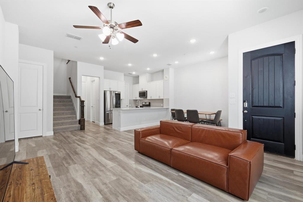 1567 Windermere Way Dallas, TX 75234 - Photo 5 of 26 a living room with furniture and kitchen view