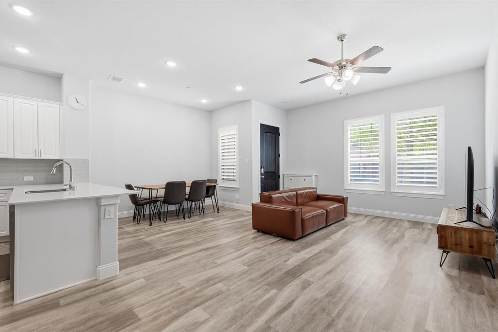 1567 Windermere Way Dallas, TX 75234 - Photo 6 of 26 a living room with furniture and a wooden floor