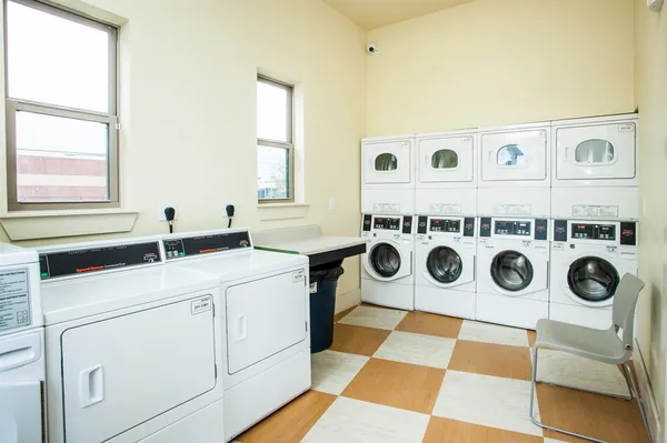 a utility room with stainless steel appliances cabinets and a stove top oven