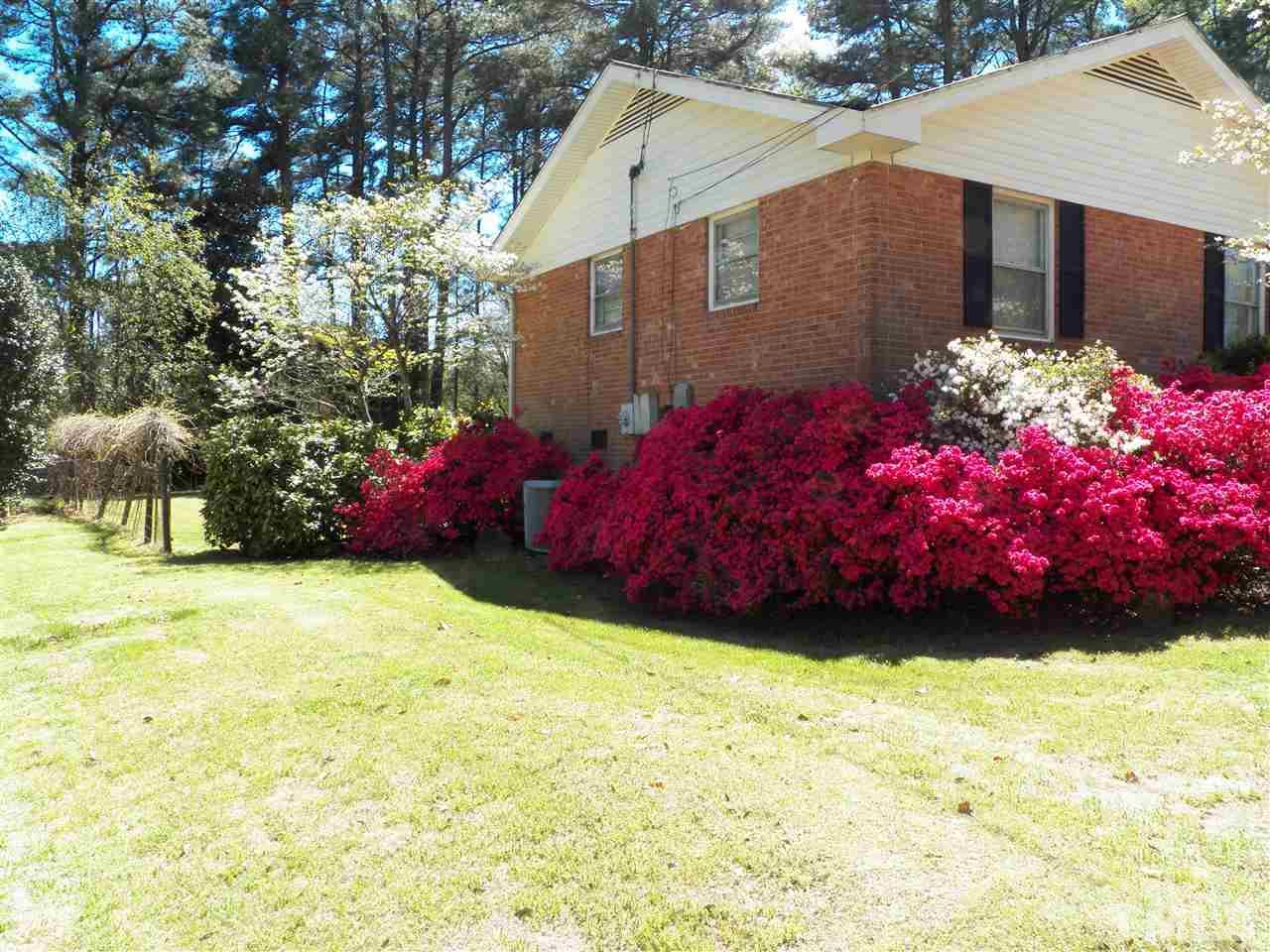 132 East Rowan Street Raleigh, NC 27609 - Photo 2 of 24 a front view of a house with a yard and garage