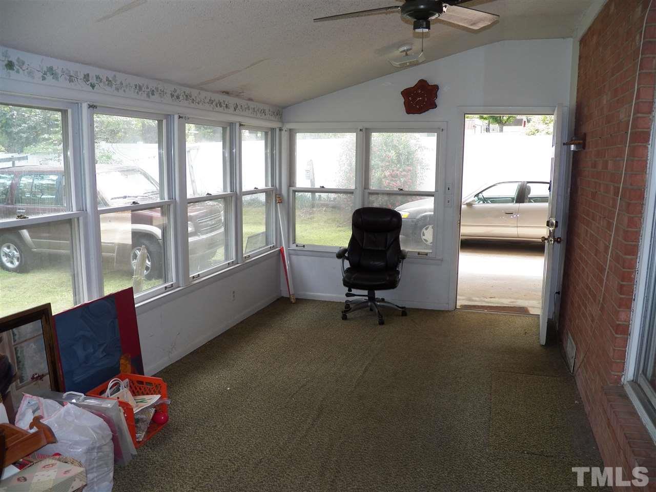 132 East Rowan Street Raleigh, NC 27609 - Photo 11 of 24 a living room with furniture and a floor to ceiling window