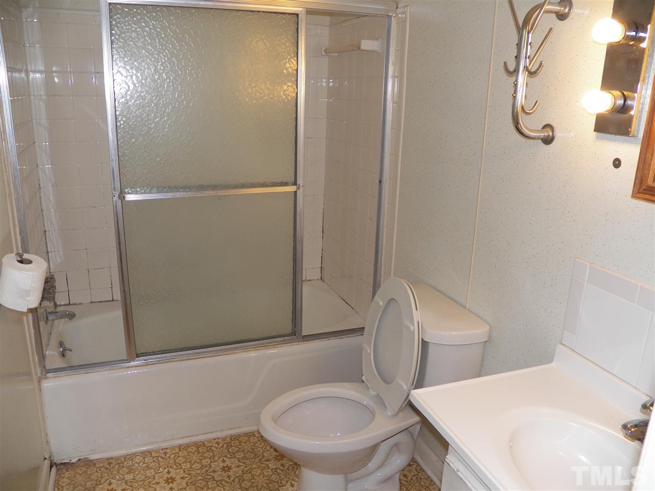 132 East Rowan Street Raleigh, NC 27609 - Photo 18 of 24 a white toilet sitting next to a bathroom sink and shower