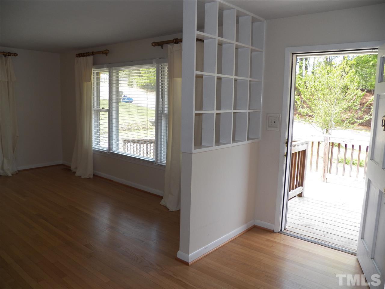 132 East Rowan Street Raleigh, NC 27609 - Photo 4 of 24 an empty room with wooden floor and windows