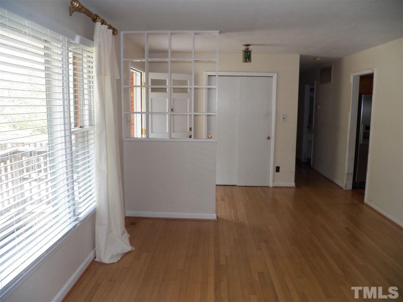132 East Rowan Street Raleigh, NC 27609 - Photo 7 of 24 an empty room with wooden floor and windows