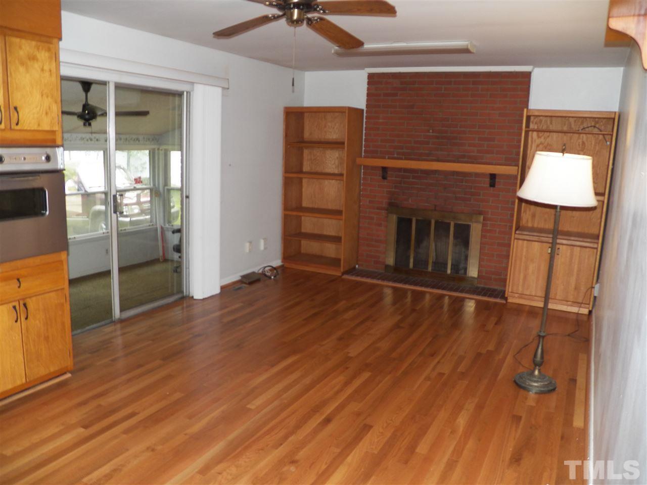 132 East Rowan Street Raleigh, NC 27609 - Photo 9 of 24 wooden floor in an empty room with a fireplace