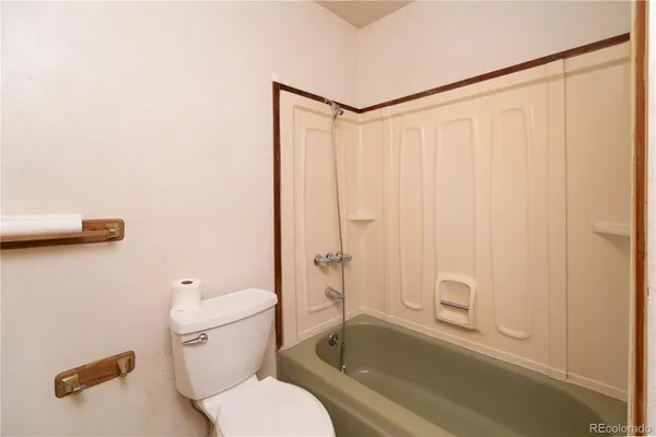 a white toilet sitting next to a bathroom sink