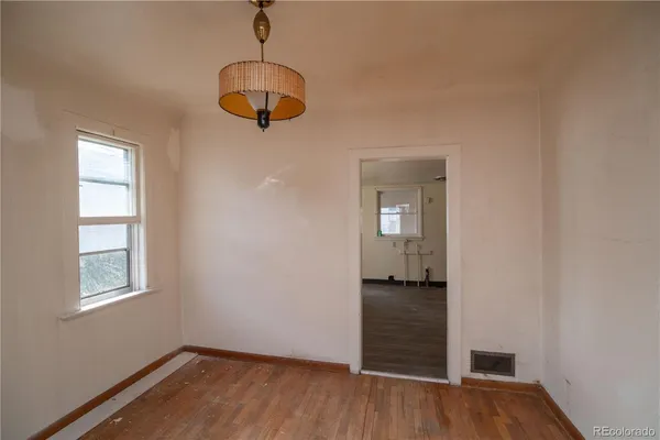 a view of a room with wooden floor and windows