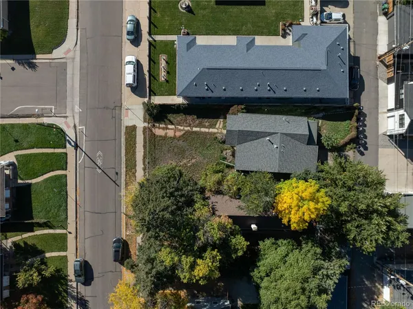 an aerial view of a house with a yard and lake view
