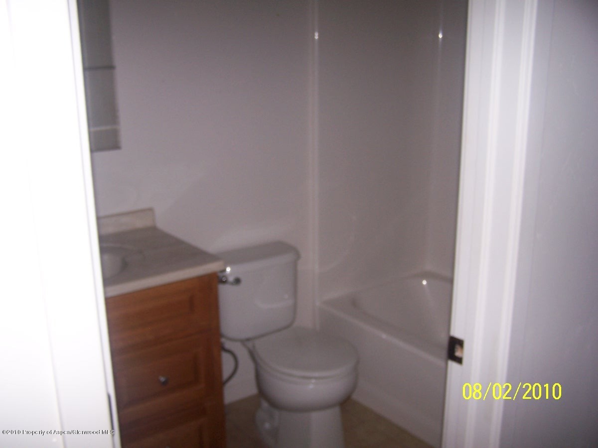 861 East 18th Street Rifle, CO 81650 - Photo 12 of 17 a white toilet sitting next to a shower