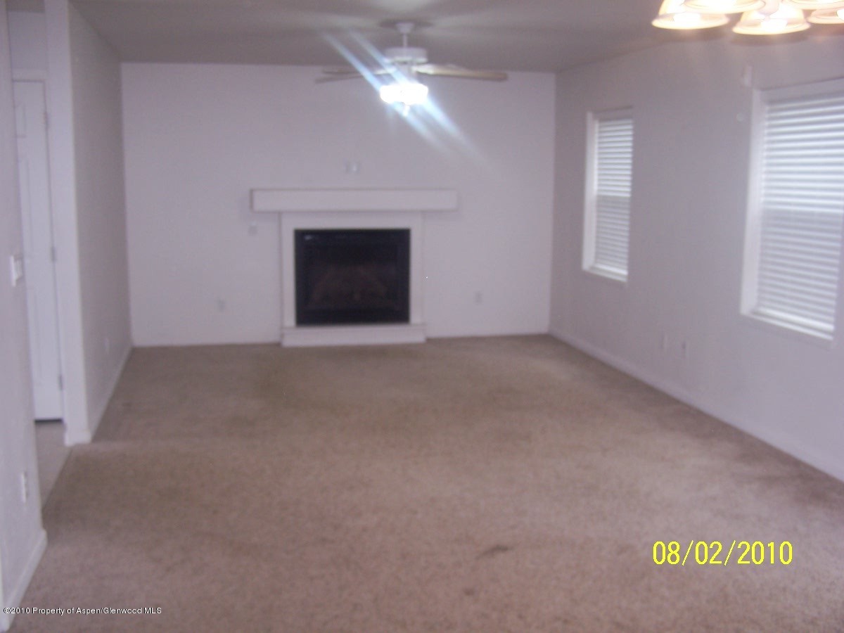861 East 18th Street Rifle, CO 81650 - Photo 2 of 17 an empty room with windows and fireplace
