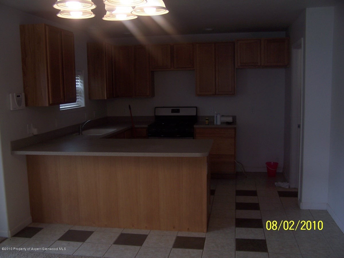 861 East 18th Street Rifle, CO 81650 - Photo 3 of 17 a kitchen with a sink and cabinets