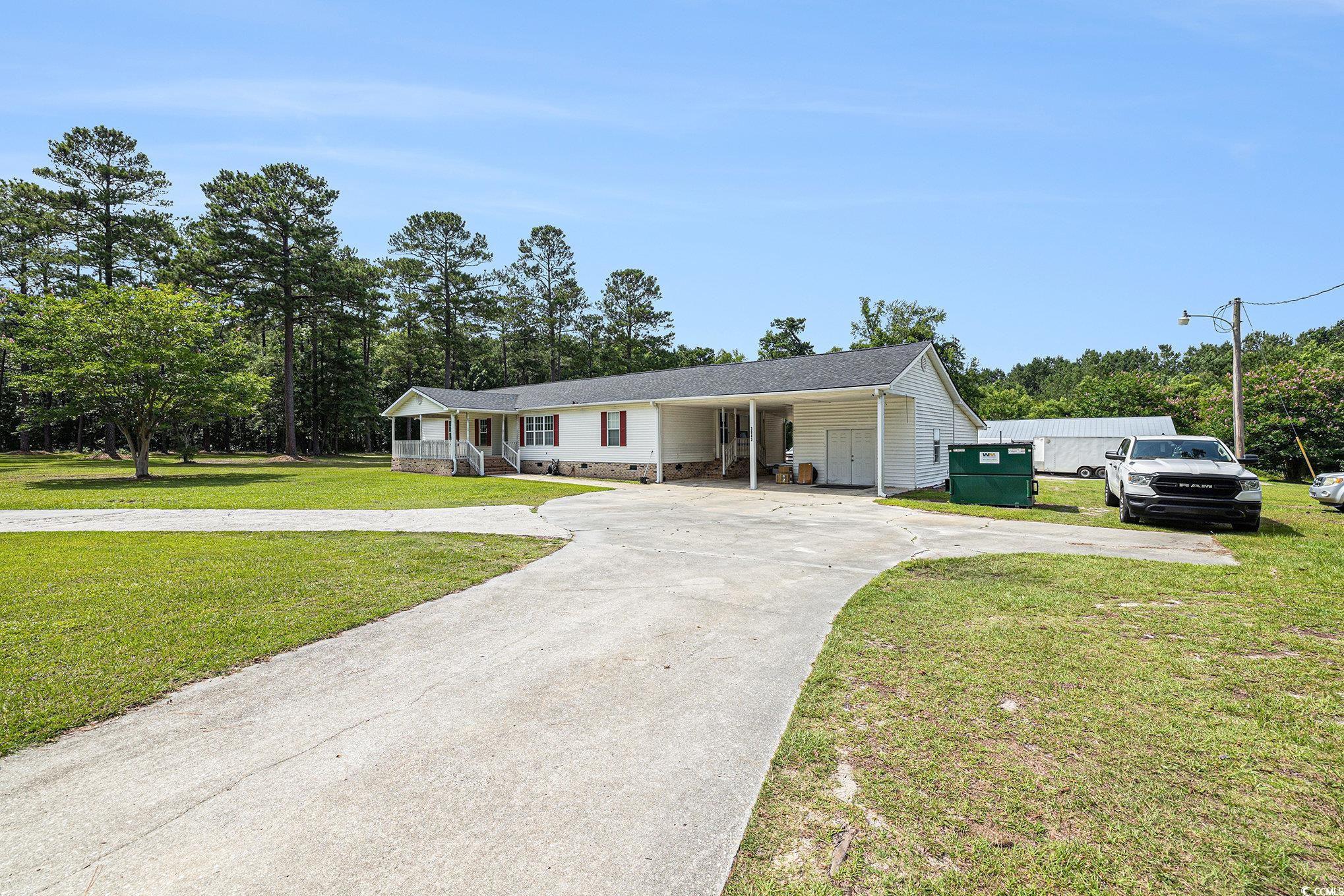 3843 Kelly Road Conway, SC 29526 - Photo 2 of 40 View of front of house featuring concrete driveway, a front yard, a carport, and crawl space