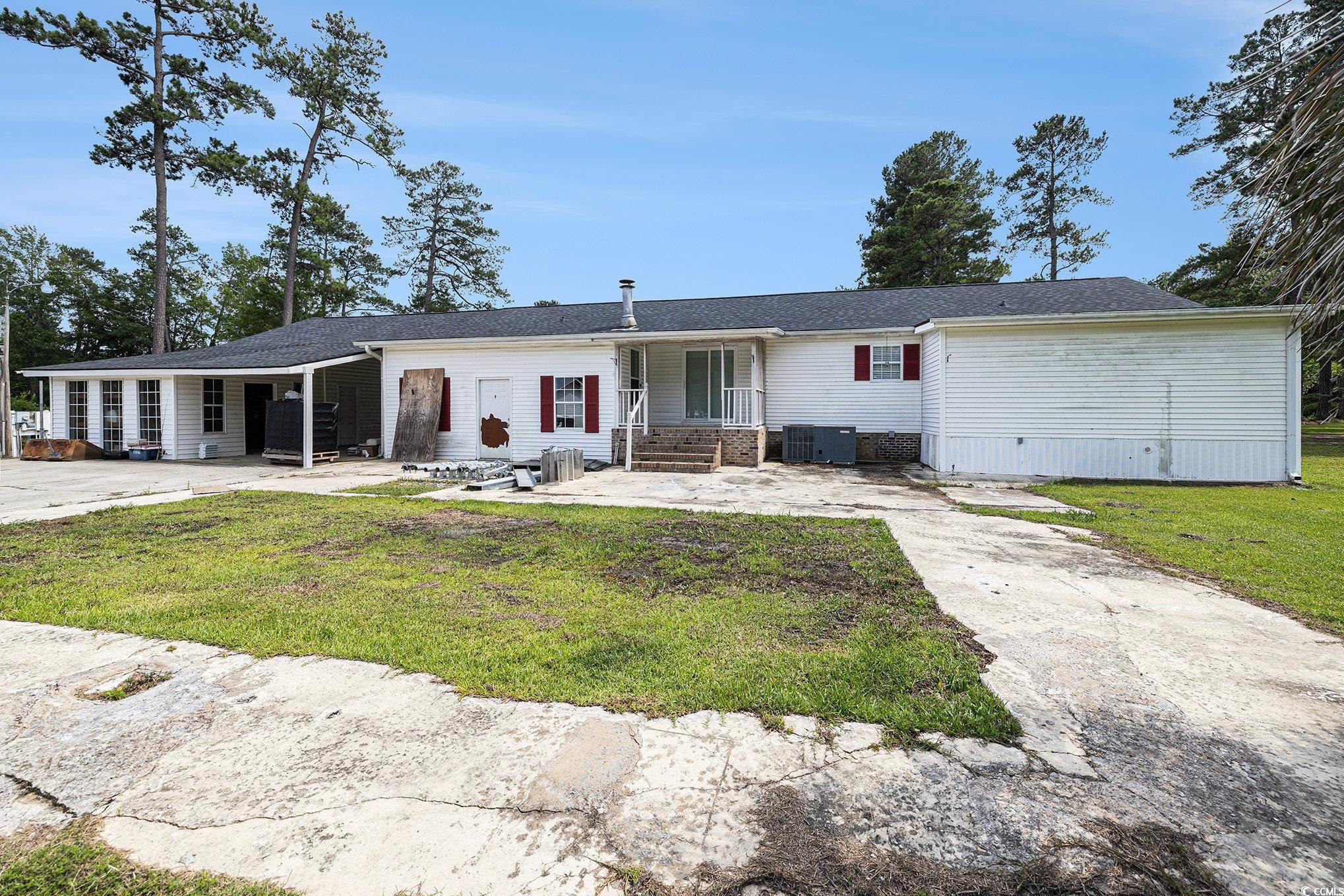 3843 Kelly Road Conway, SC 29526 - Photo 27 of 40 View of front facade featuring a front yard, concrete driveway, and brick siding