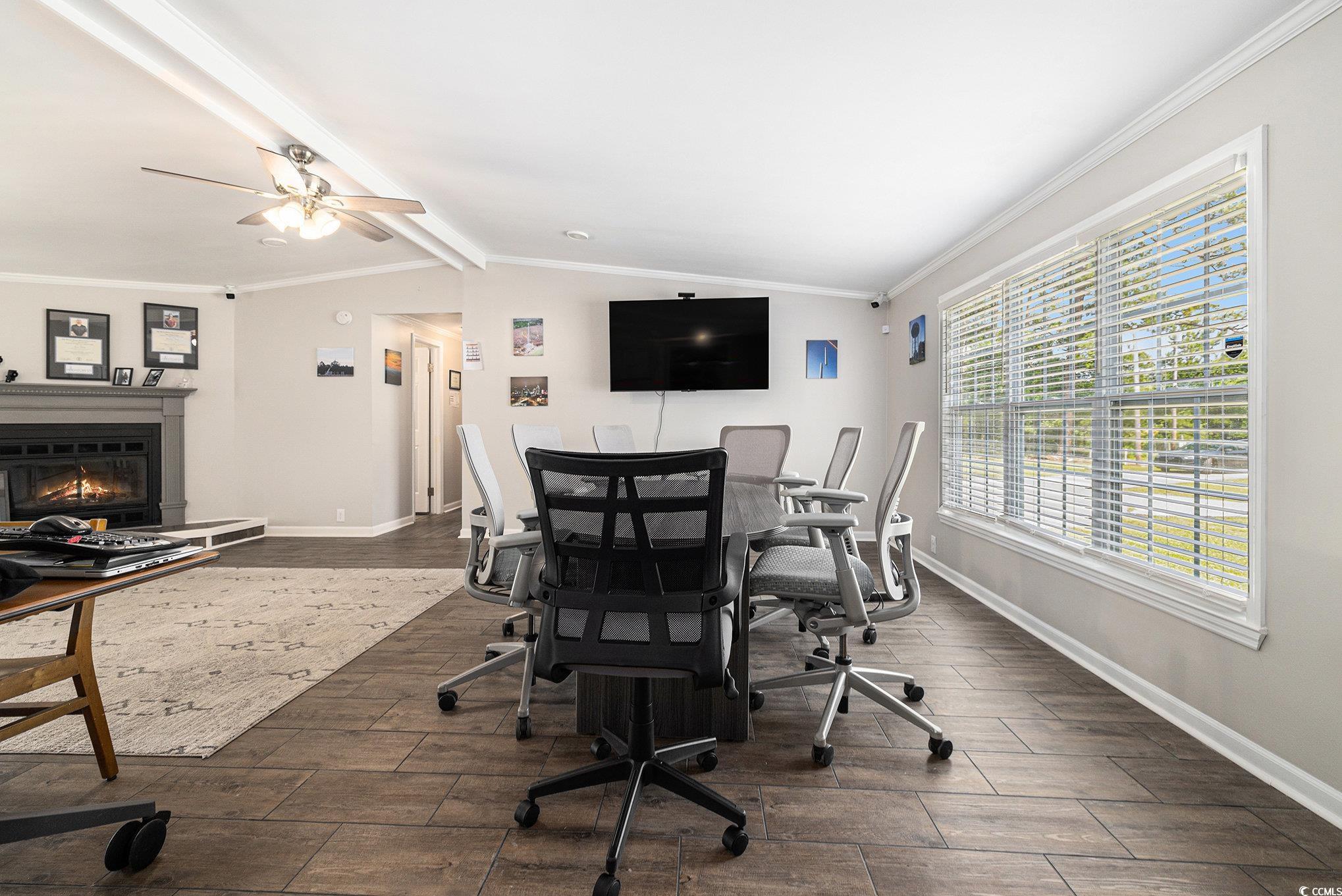 3843 Kelly Road Conway, SC 29526 - Photo 10 of 40 Home office featuring wood finished floors, plenty of natural light, ceiling fan, a glass covered fireplace, and crown molding