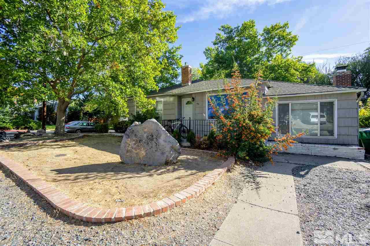 180 Bisby Street Reno, NV 89512 - Photo 2 of 13 a view of a backyard with potted plants and large tree