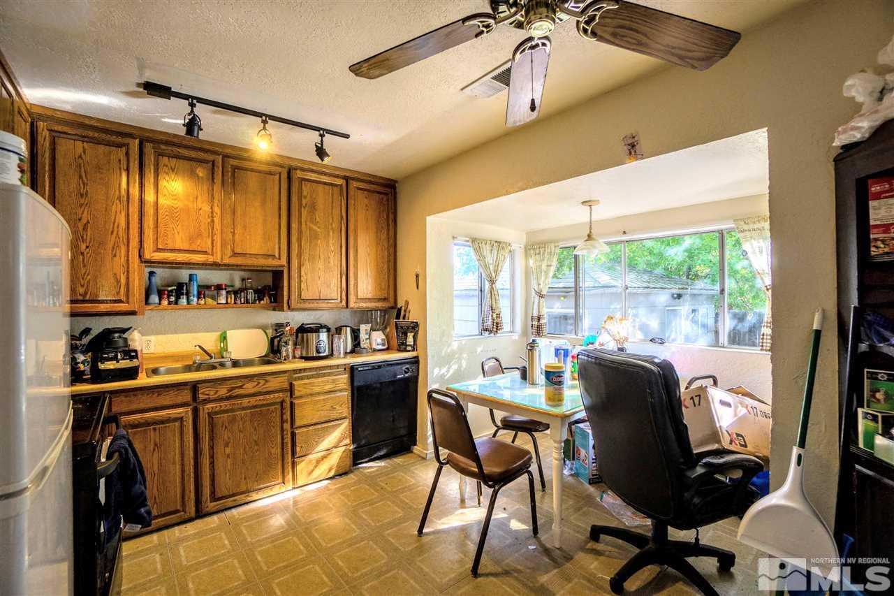 180 Bisby Street Reno, NV 89512 - Photo 4 of 13 a kitchen with a table chairs refrigerator and cabinets