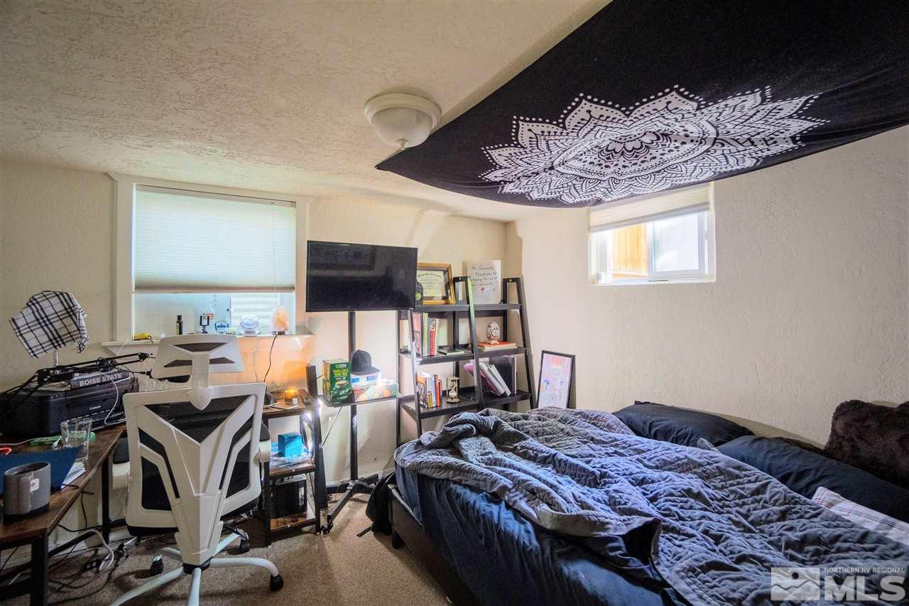 180 Bisby Street Reno, NV 89512 - Photo 6 of 13 a bedroom with bed and a flat tv screen