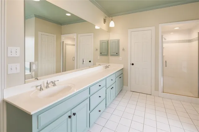 a spacious bathroom with a shower sink and mirror