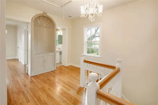 a view of a livingroom with wooden floor and a ceiling fan
