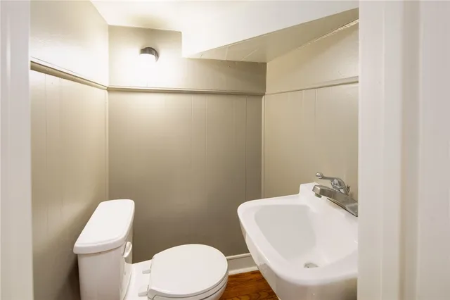 a white toilet sitting next to a bathroom sink