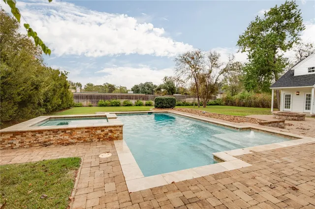 a view of swimming pool with a yard