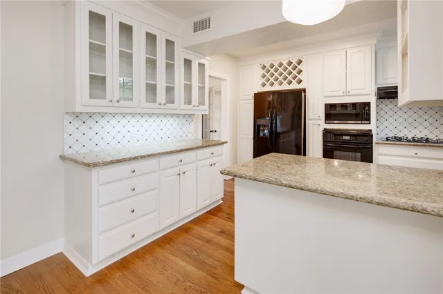 a kitchen with granite countertop a stove and a refrigerator