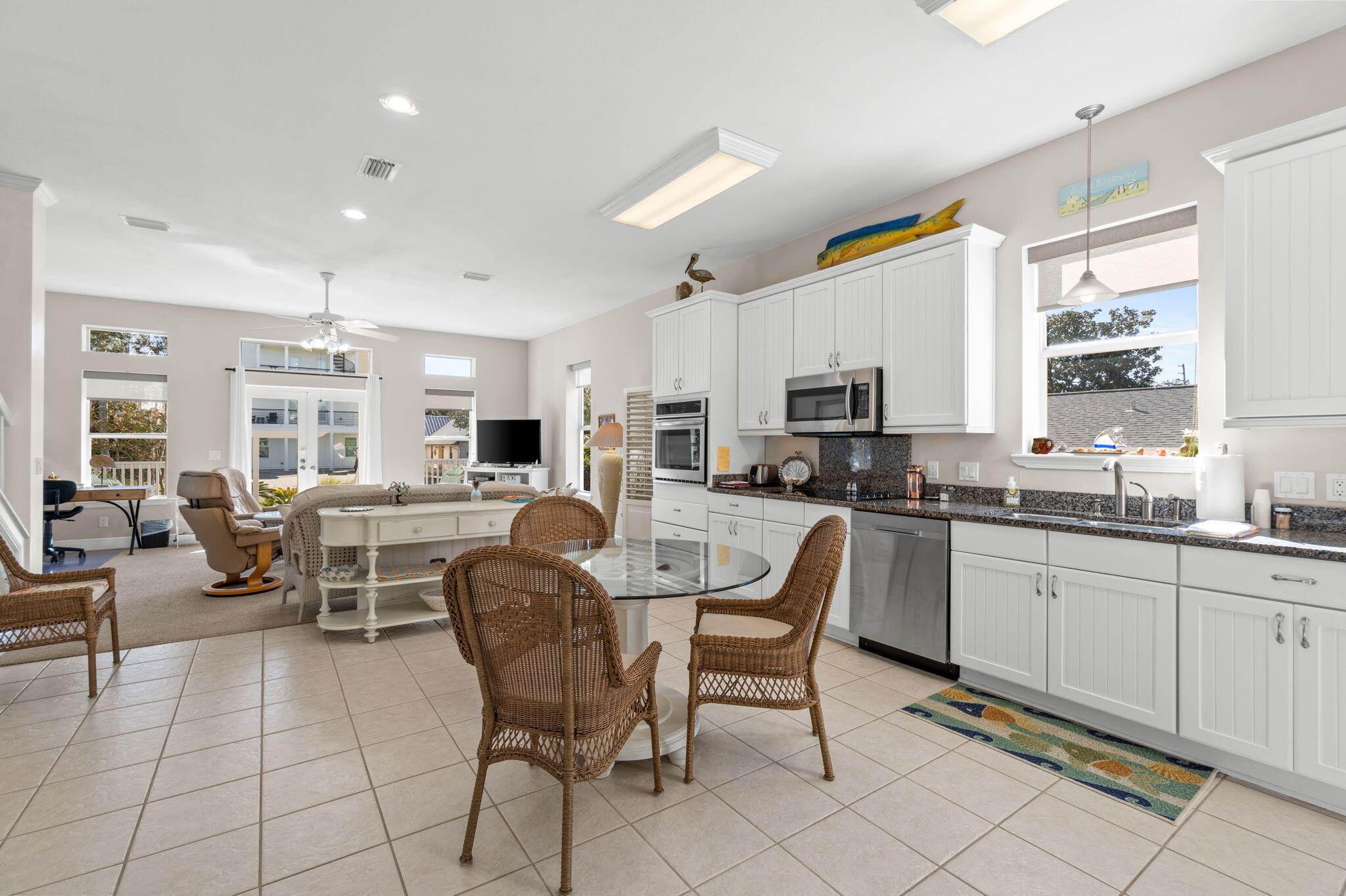 80 Dolphin Street Destin, FL 32541 - Photo 6 of 36 a living room with furniture a flat screen tv and kitchen view