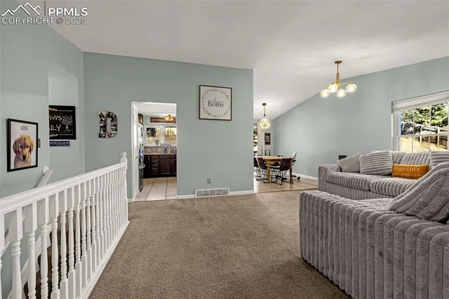 a living room with furniture and a chandelier