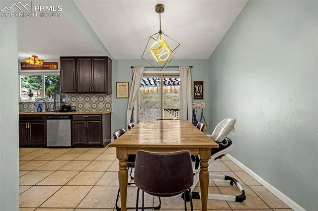 a kitchen with a table and chairs in it