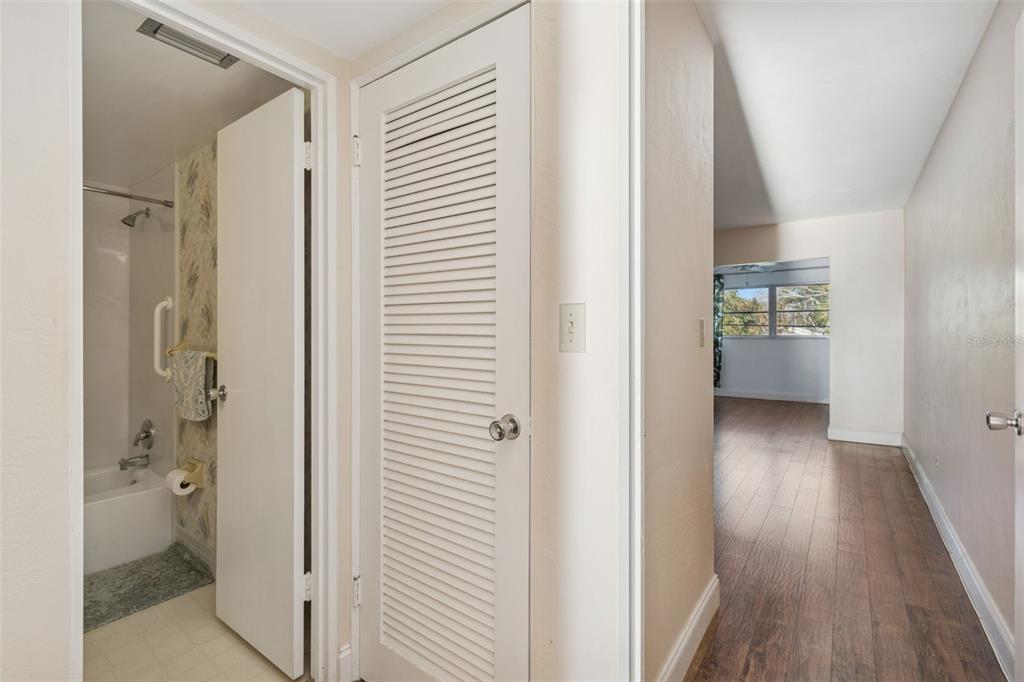 4565 Duhme Road, Unit 203 St. Petersburg, FL 33708 - Photo 11 of 27 a view of a hallway with bathroom and wooden floor