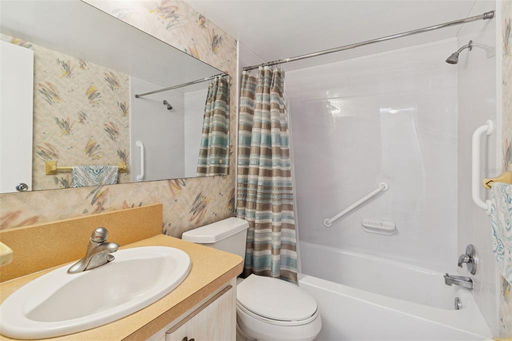 4565 Duhme Road, Unit 203 St. Petersburg, FL 33708 - Photo 12 of 27 a bathroom with a sink toilet and shower