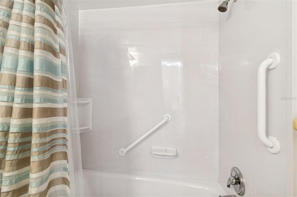 4565 Duhme Road, Unit 203 St. Petersburg, FL 33708 - Photo 13 of 27 a bathroom with a bathtub and a shower