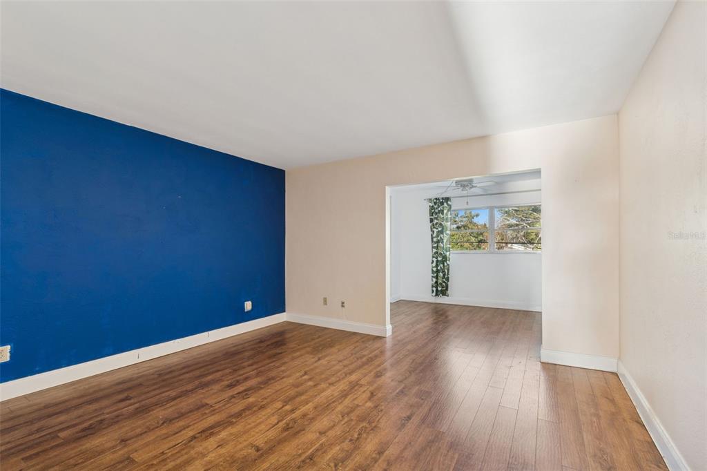 4565 Duhme Road, Unit 203 St. Petersburg, FL 33708 - Photo 14 of 27 an empty room with wooden floor and windows