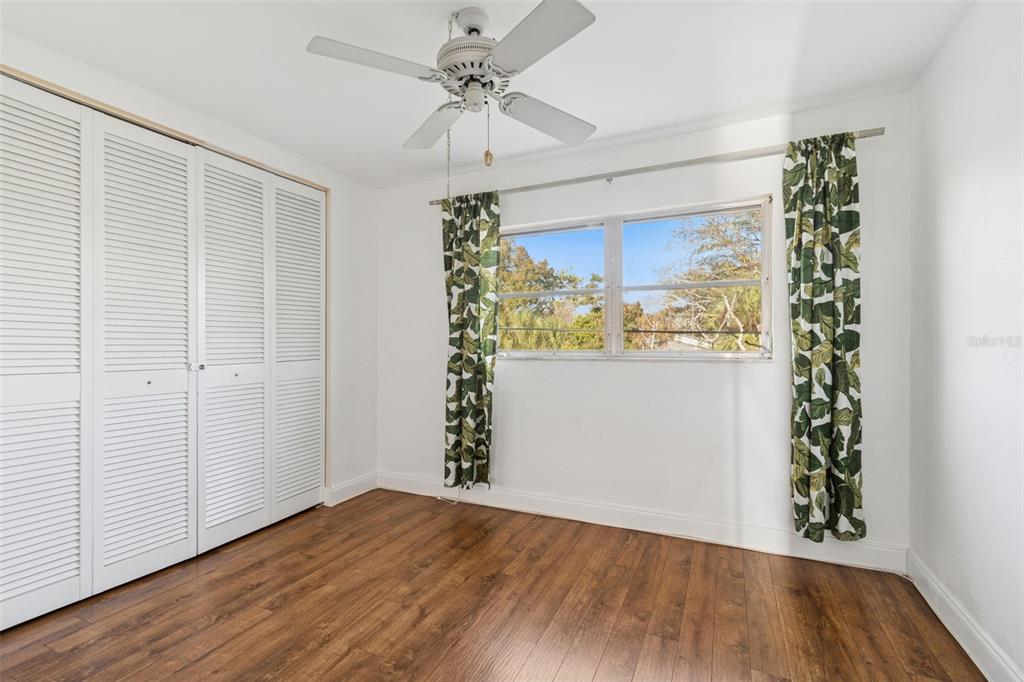 4565 Duhme Road, Unit 203 St. Petersburg, FL 33708 - Photo 17 of 27 wooden floor in an empty room with a window