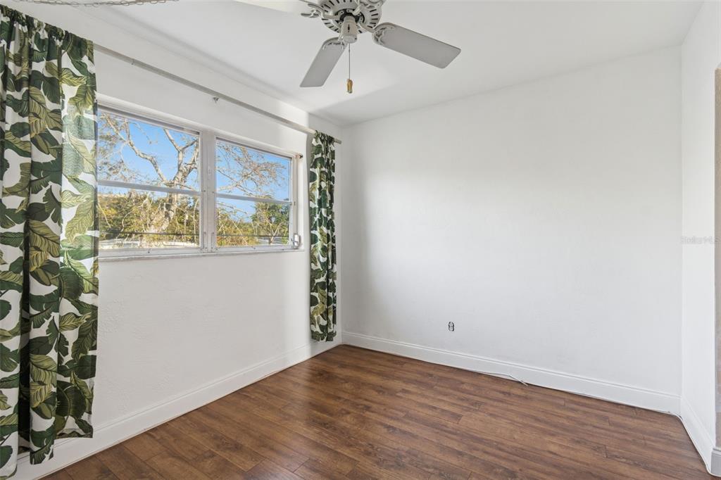 4565 Duhme Road, Unit 203 St. Petersburg, FL 33708 - Photo 18 of 27 wooden floor in an empty room with a window