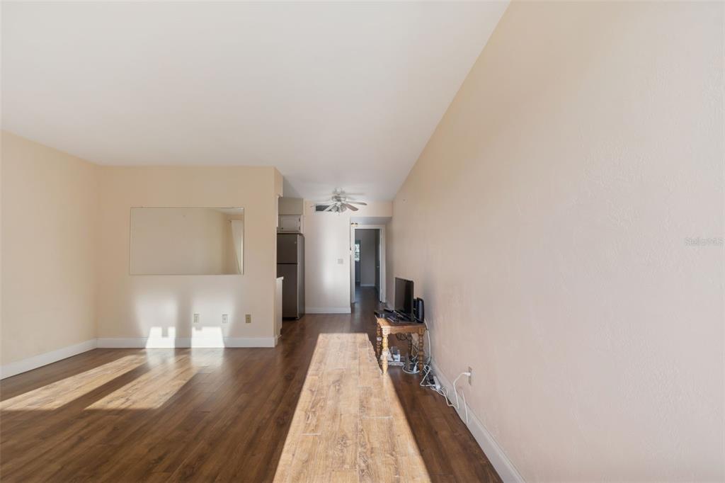 4565 Duhme Road, Unit 203 St. Petersburg, FL 33708 - Photo 3 of 27 a view of a hallway with wooden floor and a bathroom