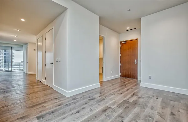 a view of hallway with wooden floor