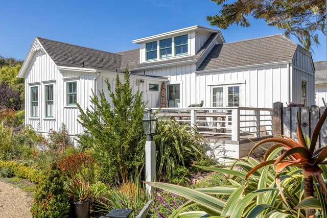 a view of a house with a yard and sitting area