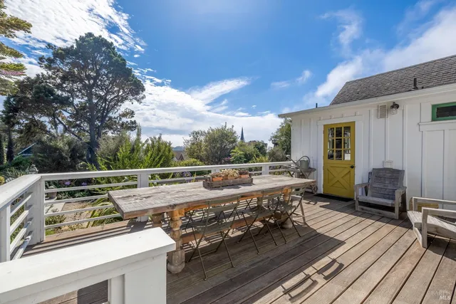 a view of a roof deck with couches and wooden floor