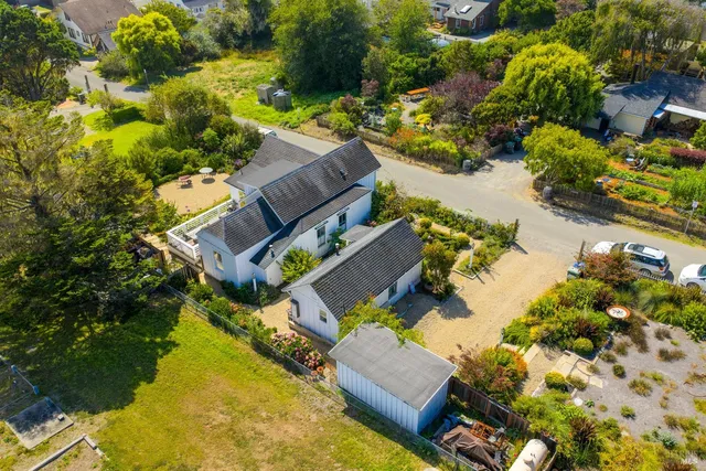 an aerial view of a house with a yard and swimming pool