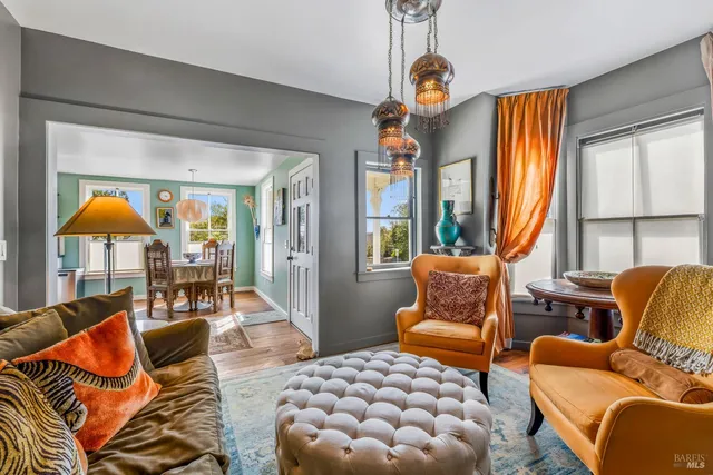 a living room with furniture a fireplace and a window