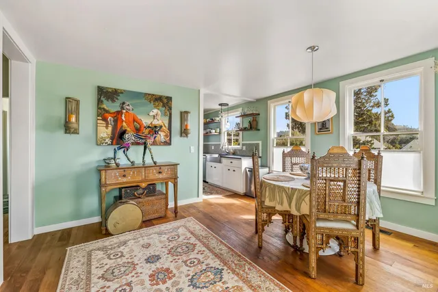 a view of a livingroom with furniture window and wooden floor