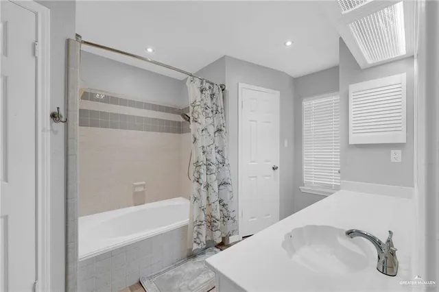 a bathroom with a bathtub and shower