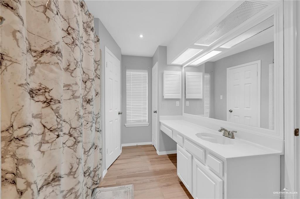 1409 Heritage Oaks Road Edinburg, TX 78539 - Photo 13 of 18 a bathroom with a sink a mirror and a shower