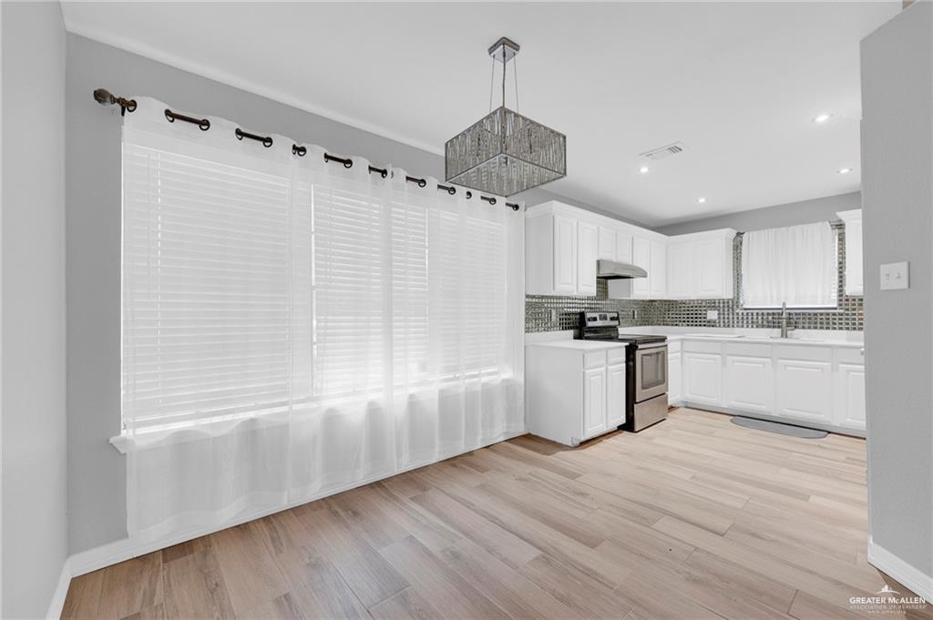 1409 Heritage Oaks Road Edinburg, TX 78539 - Photo 4 of 18 a kitchen with a refrigerator a sink and cabinets