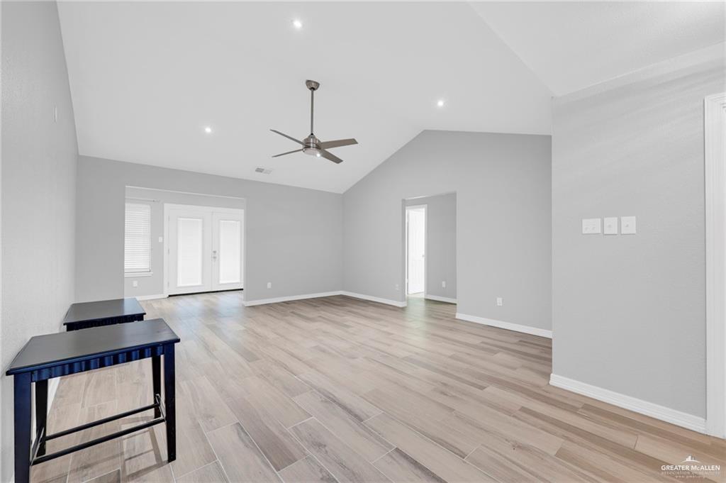 1409 Heritage Oaks Road Edinburg, TX 78539 - Photo 5 of 18 a view of an empty room with wooden floor and a window