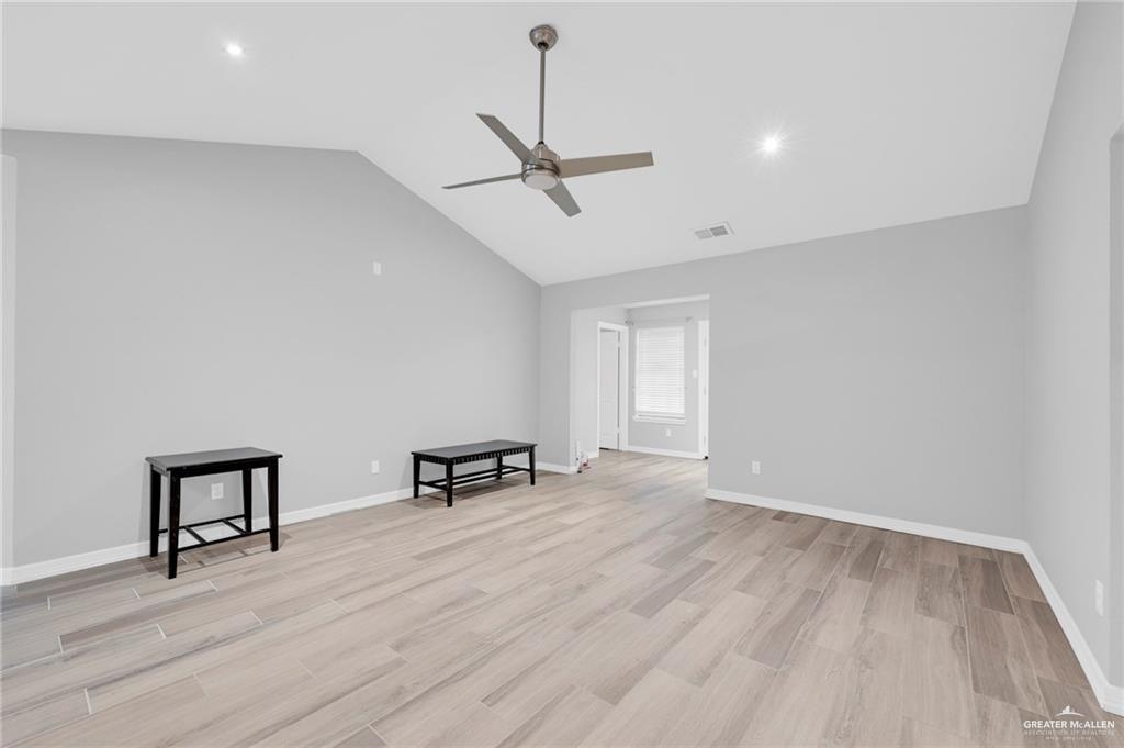 1409 Heritage Oaks Road Edinburg, TX 78539 - Photo 6 of 18 a view of an empty room with window and wooden floor