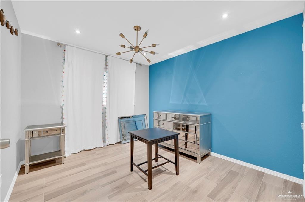 1409 Heritage Oaks Road Edinburg, TX 78539 - Photo 8 of 18 a view of a hallway with furniture and a chandelier