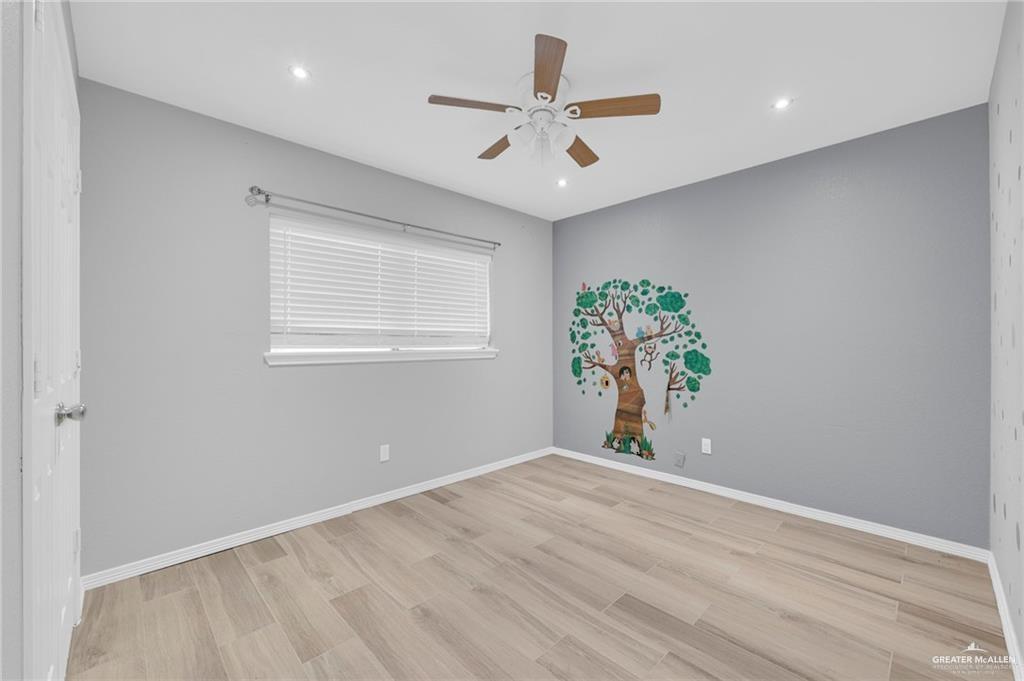 1409 Heritage Oaks Road Edinburg, TX 78539 - Photo 10 of 18 wooden floor in an empty room with a window